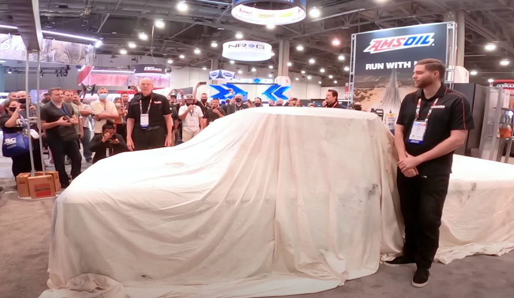 The crowd gathers around to watch the revealing of LokJaw at the 2022 SEMA Show.