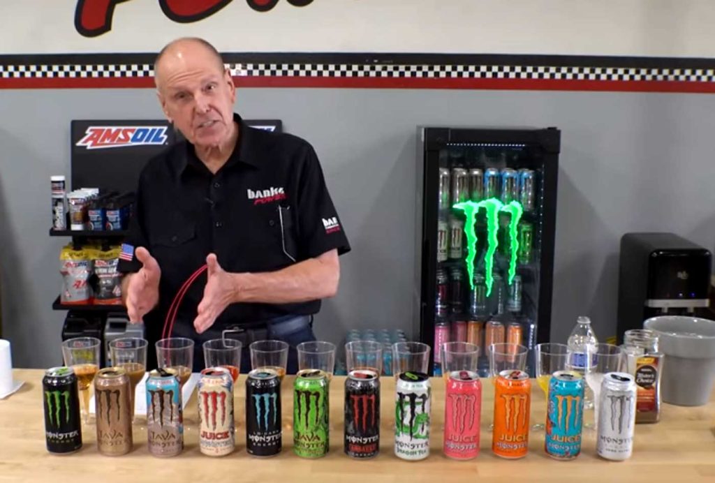 Gale standing in front of every flavor of Monster Energy Drink before taste testing them. 
