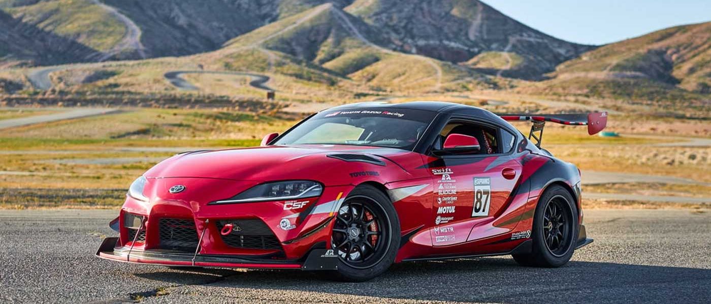 Toyota Supra parked on track, in front of mountains