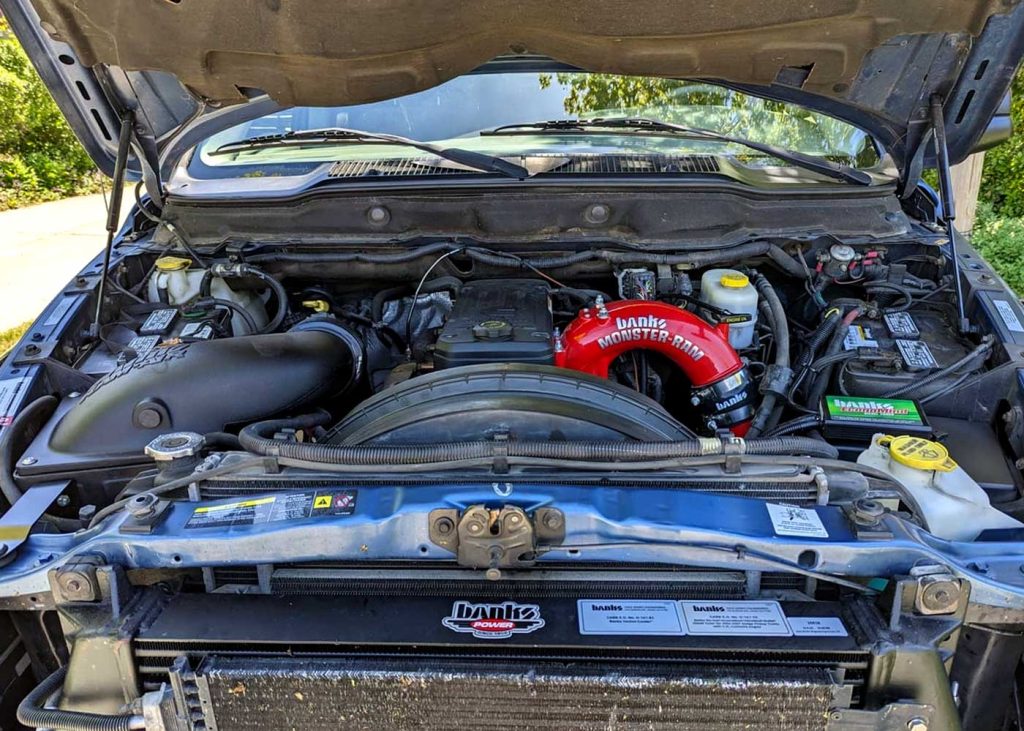 The engine compartment of the 2003 Dodge RAM decked out in Banks parts.