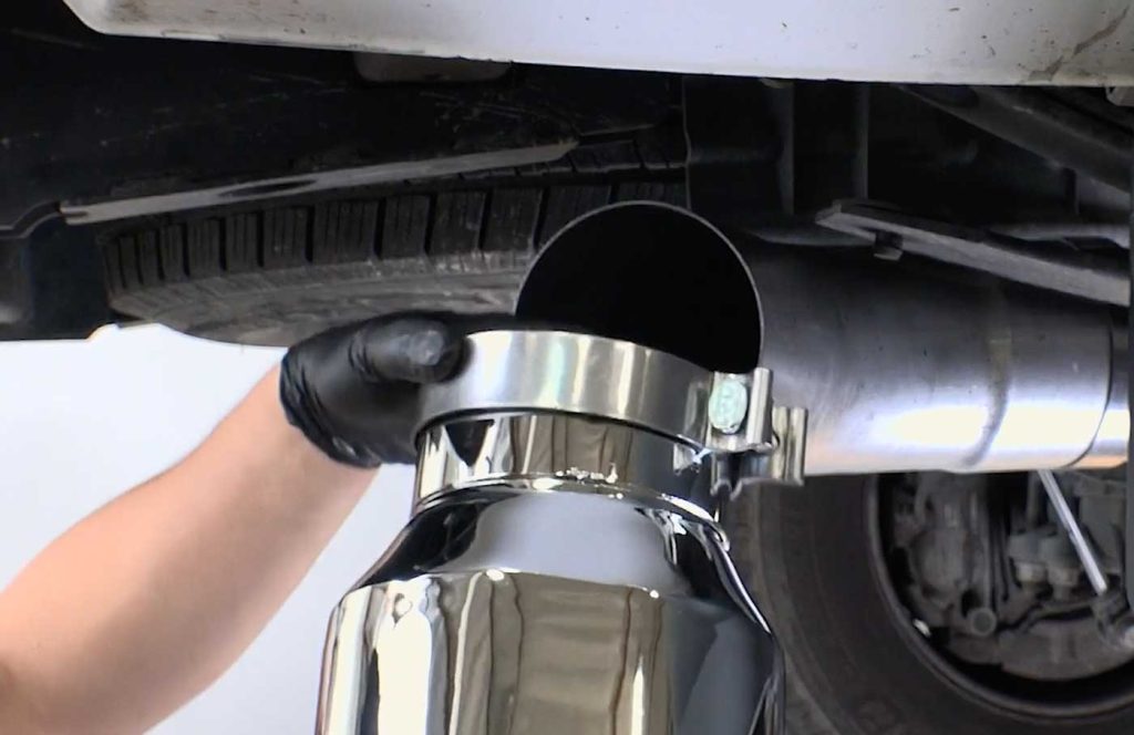 Place the remaining five-inch clamp over the exhaust tip. Then slide the tip onto the rear exhaust pipe.
