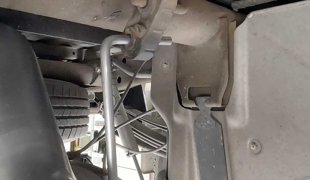 Moving to the back, place the exhaust hanger into the rubber hangers and rotate the tailpipe until the hanger pin is parallel to the frame-mounted pin.