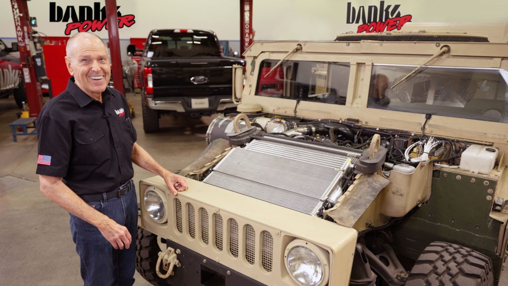 Gale Banks stands with a Banks Hybrid HMMWV